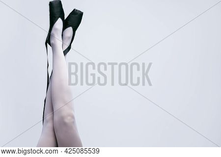 Closeup Of Female Ballet Dancer Legs In Laced Pointes Shoes. Posing With Straight And Crossed Legs.