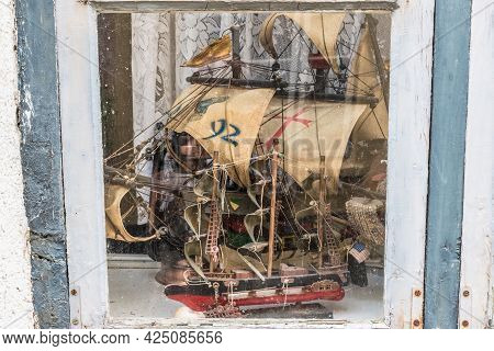 Models Of Ancient Ships And Boats Behind Old Window
