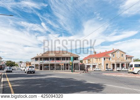 Caledon, South Africa - April 12, 2021: A Street Scene, With Old Buildings, People And Vehicles, In 