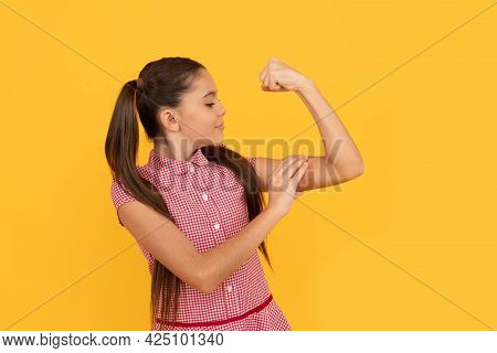 Girl Power. Female Child Flex Arm Yellow Background. Gesture Of Power And Strength. Crl Pwr