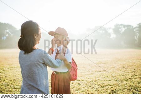 Mother Fixing Her Daughter Primary School Student Uniform