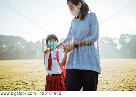 Mother And Her Daughter Walking Together And Wear Face Mask