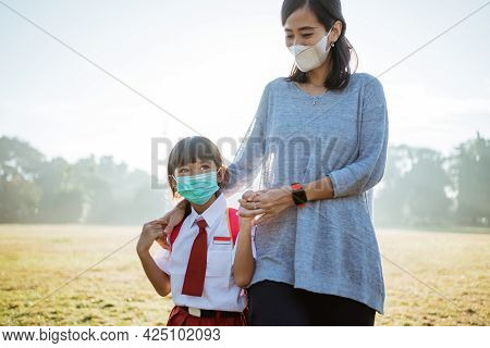 Mother And Her Daughter Walking Together And Wear Face Mask