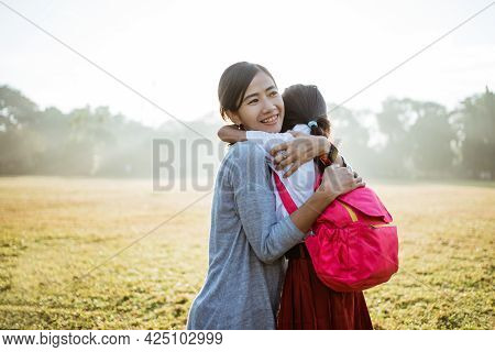 Asian Mother Embrace And Hug Her Daughter Going To School