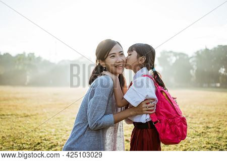 Mother Taking Her Daughter To School In The Morning