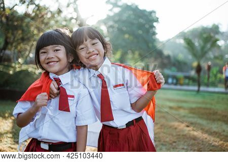 Indonesian School Student Holding Flag During Independence Day.
