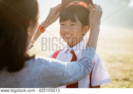 Mother Fixing Her Daughter Primary School Student Uniform
