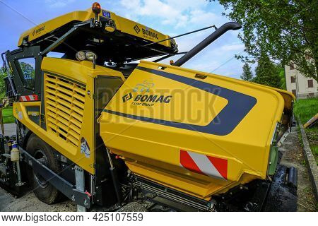 June 2021 Parma, Italy: Huge Yellow Bomag Heavy Road Machine Close-up Parked And Ready For Road Cons