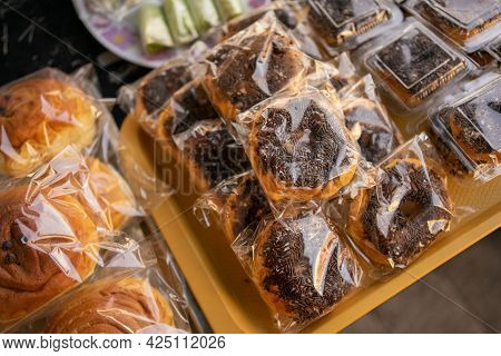 Donuts With Mesis Wrapped In Plastic On A Serving Plate On The Table