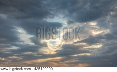 Sky Background With Beautiful Heavy Dark Gray, Almost Black Stormy Clouds. Blue Sky Is Visible Throu