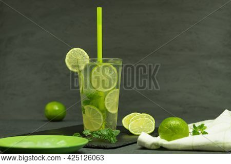 A Glass Of Lemonade And Ice With Lime. Homemade Mojito Lemonade, With Lime And Mint In A Glass Jar O