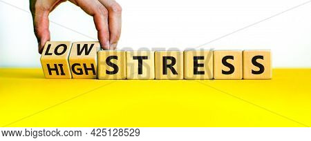 Low Or High Stress Level Symbol. Businessman Turns Wooden Cubes And Changes Words High Stress To Low