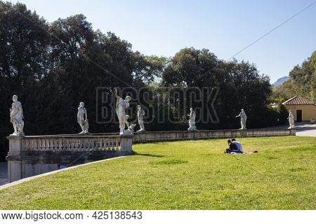 Royal Palace In Caserta, Italy - April 10, 2017: Reggia Di Caserta, Tourists Are Resting On The Gree