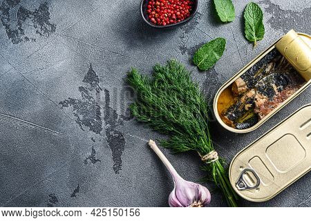 Sardinops In Oil In Preserve Canned Food,closed And Open Can Jar Woth Herbs And Garlic Ocer Grey Bac