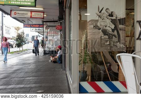 Auckland New Zealand - June 19 2021;karangahape Road Street Scene Of Barber Shop Window And People U