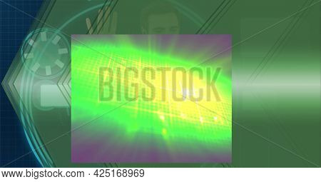 Composition of glowing green light over digital interface and man using computer. global communication and digital interface technology concept digitally generated image.