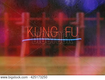 Vintage Neon Martial Arts Sign On Black Background Kung Fu With Wooden Dummy In Background