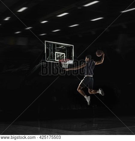 Young African Sportsman, Basketball Player Training In Gym, Idoors Isolated On Dark Background. Conc