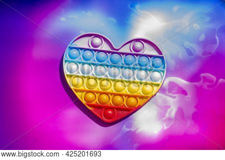 Fashionable Toy For Children Pop It. Anti-stress Finger Blisters. Heart Shaped Silicone Poppit Rainb