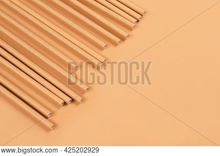 Close Up View Of Eco-friendly Paper Drinking Straws On Light Brown Paper Background With Copy Space.