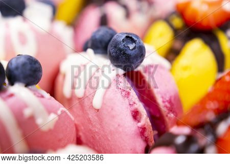 Traditional French Macaroons With Bluebarry And Strawberry. Colourful And Delicious Dessert With Cho