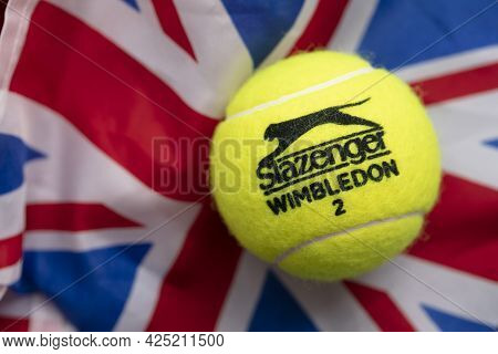 London, Uk - June 2021: Official Wimbledon Tennis Slazenger Ball On Uk Flag