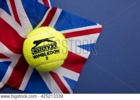London, Uk - June 2021: Official Wimbledon Tennis Slazenger Ball On Uk Flag