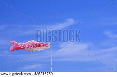 Pink Koi Fish Flag Against White Cloud And Blue Sky In Minimal Style