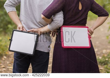 Woman And Man Stand Backwards And Hold With Plates