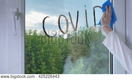 Doctor's Hand Cleaning Word Covid From Window. Ending Of Covid-19 Coronavirus Pandemic