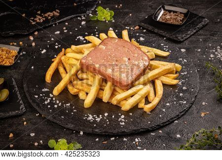 Leberkase Or Slice Of Meat Loaf With Cheese Served With French Fries