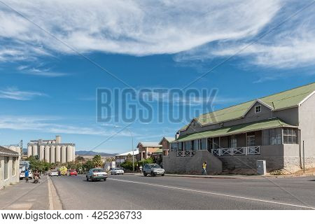 Caledon, South Africa - April 12, 2021: A Street Scene, With Buildings, People And Vehicles, In Cale