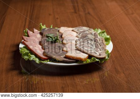 Meat Delicacies Slicing, Cold Cuts, Beef Meat, Smoked Turkey, Horse Meat In A White Plate On The Tab