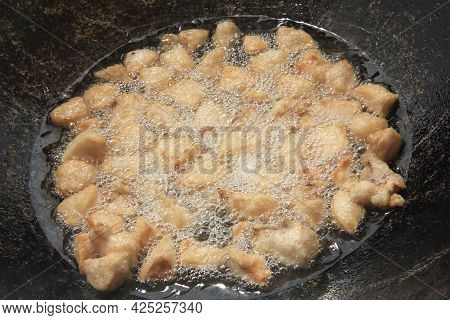 Large Chunks Of Raw Lamb Fat Dumba Are Fried In Oil With Bubbles In A Black Cauldron Close-up, Cooki