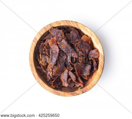 Sliced beef jerky in bowl. Dried beef meat isolated on white background.