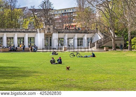 Berlin, Germany - April 25, 2021: Playgrounds Of The Rudolph Wilde Park With People Enjoying The Spr