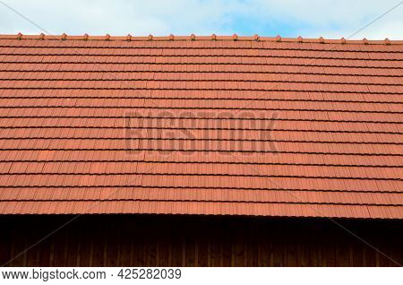 View Of The Roof Made Of Red Brick Burnt Tiles Of The Beaver Type Used In Central Europe On All Hist