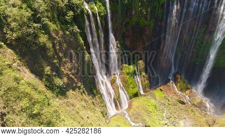 Beautiful Waterfall Coban Sewu In Tropical Forest, Java Indonesia. Aerial View Tumpak Sewu Waterfall