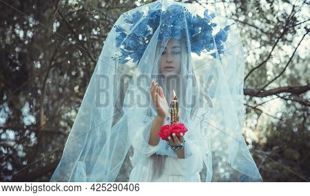Beautiful Girl In Wreath Of Flowers In Forest. Portrait Of Young Beautiful Woman Wearing White Bride