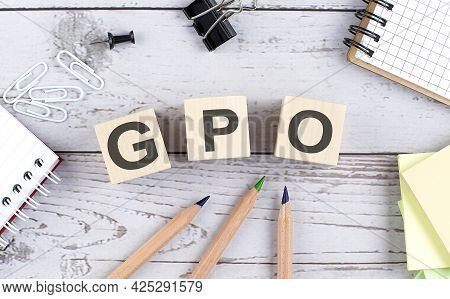 Gpo - Group Purchasing Organization Text On Wooden Block With Office Tools On Wooden Background