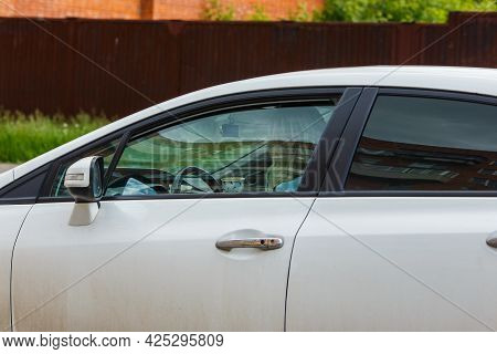 Unidentifiable Blonde Long Hair Woman Driving White Car With Paper Coffee Cup
