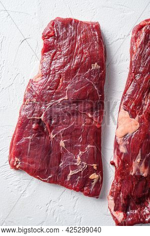 Raw Skirt Steak, Flank Steak, For Bbq  Cut Organic Meat Cut Top View Close Up Over White Concrete Ba