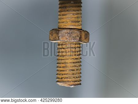 Old Rusty Bolt, Iron Rod With Screw Threads. Rusted Mechanical Components. Threaded Bolt And Nut Iso