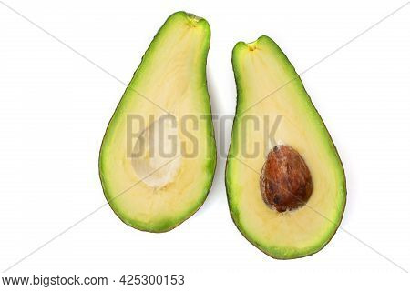 Two Halves Of Avocado Slices Isolated On A White Background