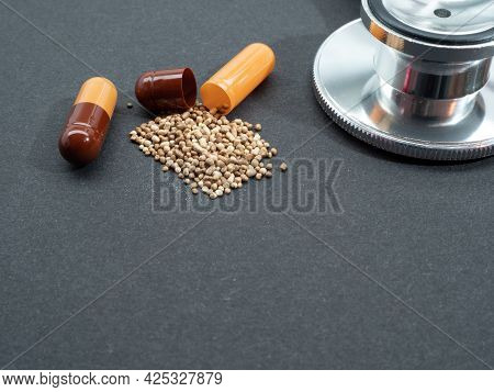 Capsules And Stethoscope On A Black Background. Capsules Lie On A Black Background. Close Up.