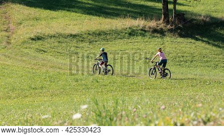 Two Girls On Mtb Bikes. Mother And Daughter Riding On A Trail.
