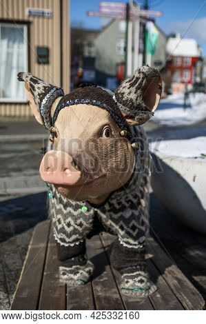 A Pig Statue Dressed In Traditional Icelandic Wool Sweater, In Front Of Saeta Svinid Gastropub, Reyk