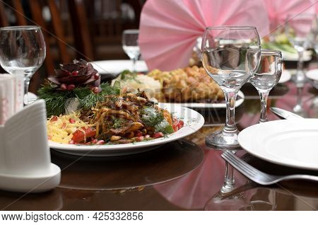 Fried Lagman Noodles With Pieces Of Meat And Vegetables In A Plate On The Banquet Table