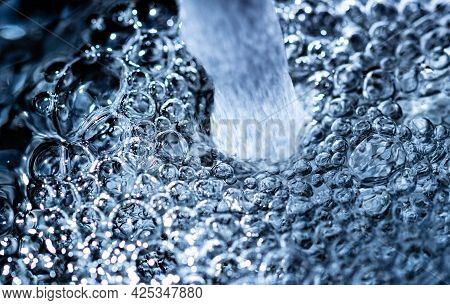 Water Bubbles Close-up. Tap Water From A Faucet. Extreme Macro Close-up. Tap Water. High Quality Fot