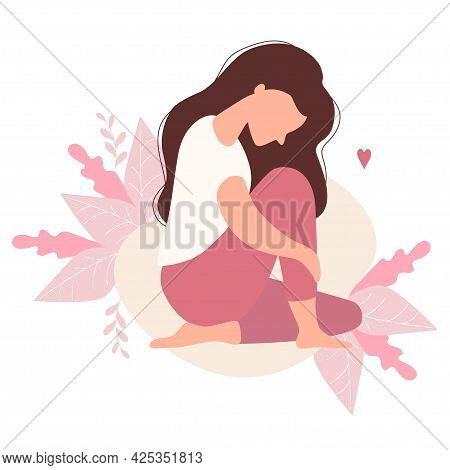 Beautiful Modern Sad Girl With Long Hair Sits Hugging Her Leg On A Decorative Background With Tropic